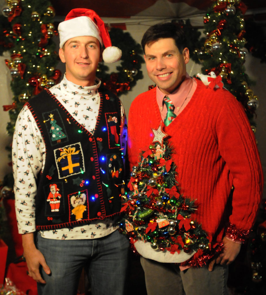 1st Lt. Jaymes Bell and John Montgomery, both platoon leaders with Company B., 1st ,"Mustangs" Battalion, 8th Cav. Regt., 2nd BCT, 1st Cav. Div., sport the sweaters they will enter into the ugly sweater contest during the Mustang Winter Fest Christmas Party here, Dec. 11. (Photo by Sgt. Quentin Johnson, 2BCT, 1st Cav Div PAO)